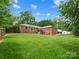 Expansive backyard featuring a well-manicured lawn, brick home, and deck, perfect for outdoor enjoyment at 3367 Tanglewood Dr, Rock Hill, SC 29732