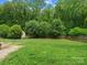 Large, well-maintained backyard featuring lush green grass, privacy fence, mature trees, and storage shed at 3367 Tanglewood Dr, Rock Hill, SC 29732