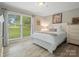 Bright bedroom featuring a large window, a comfortable bed, and light wood-look floors at 3367 Tanglewood Dr, Rock Hill, SC 29732
