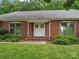 Close-up view of a brick home featuring a double door entrance and manicured front yard at 3367 Tanglewood Dr, Rock Hill, SC 29732