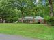 Charming brick home with a manicured lawn and mature trees, creating a serene and inviting curb appeal at 3367 Tanglewood Dr, Rock Hill, SC 29732