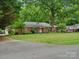 Charming brick home with a manicured lawn and mature trees, creating a serene and inviting curb appeal at 3367 Tanglewood Dr, Rock Hill, SC 29732