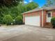 Attached two-car garage with a wide driveway, brick accents, and manicured landscaping at 3367 Tanglewood Dr, Rock Hill, SC 29732