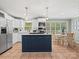 Bright kitchen with white cabinets, stainless steel appliances, and a central island with a navy-blue base at 3367 Tanglewood Dr, Rock Hill, SC 29732