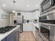 Bright kitchen with stainless steel appliances, white cabinets, and a center island with cooktop at 3367 Tanglewood Dr, Rock Hill, SC 29732