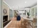 Open concept kitchen features white cabinetry, a center island, and a breakfast nook, seamlessly connected to a brick fireplace at 3367 Tanglewood Dr, Rock Hill, SC 29732