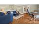 Cozy living room with blue sofas, hardwood floors, and a view into an adjacent room at 3367 Tanglewood Dr, Rock Hill, SC 29732