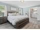 Comfortable main bedroom with a light blue wall, a wooden bed and a vanity with a mirror on top at 3367 Tanglewood Dr, Rock Hill, SC 29732