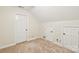 Attic with neutral carpet features three white paneled doors at 3916 Blowing Rock Way, Charlotte, NC 28210