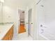 Bright bathroom featuring a tub/shower combo and wood cabinets at 3916 Blowing Rock Way, Charlotte, NC 28210