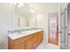 Bathroom featuring a double sink vanity, large mirror, and tiled accents for a stylish look at 3916 Blowing Rock Way, Charlotte, NC 28210