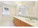 Bathroom with double vanity, framed mirror, tiled backsplash, and white tiled floors at 3916 Blowing Rock Way, Charlotte, NC 28210