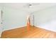 Well-lit bedroom with hardwood floors, ceiling fan, and a doorway to the rest of the house at 3916 Blowing Rock Way, Charlotte, NC 28210