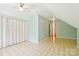 Bright bedroom with ceiling fan, large window, vinyl flooring, and access to other rooms at 3916 Blowing Rock Way, Charlotte, NC 28210