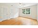 Bright bedroom with hardwood floors, ceiling fan, and a large window with natural light at 3916 Blowing Rock Way, Charlotte, NC 28210