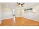 Bright bedroom features parquet floors, ceiling fan, and sconce lighting at 3916 Blowing Rock Way, Charlotte, NC 28210