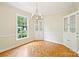 Elegant dining room with a chandelier, large windows, and built-in cabinets, ideal for gatherings at 3916 Blowing Rock Way, Charlotte, NC 28210