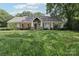 Charming single-story home featuring red shutters, a well-manicured lawn, and inviting curb appeal at 3916 Blowing Rock Way, Charlotte, NC 28210