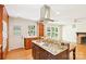 Bright, open kitchen with center cooktop island, wooden cabinets, and access to the outdoors at 3916 Blowing Rock Way, Charlotte, NC 28210