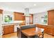 Bright kitchen with wooden cabinets, stainless steel hood vent, and granite countertops at 3916 Blowing Rock Way, Charlotte, NC 28210