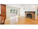 Bright living room with a brick fireplace, hardwood floors, and glass doors leading to outdoor patio at 3916 Blowing Rock Way, Charlotte, NC 28210