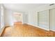 Bright and airy living room with hardwood floors, large windows, and built-in bookshelves at 3916 Blowing Rock Way, Charlotte, NC 28210