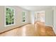 Spacious living room with beautiful hardwood floors, natural light, and open doorway to dining room at 3916 Blowing Rock Way, Charlotte, NC 28210