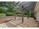 An inviting outdoor patio featuring a brick surface and a wooden pergola, perfect for entertaining and relaxation at 3916 Blowing Rock Way, Charlotte, NC 28210