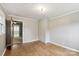Bright bedroom with wood floors and neutral walls, with doorway view to another room at 407 Cherry St, Belmont, NC 28012