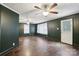 Spacious living room featuring two ceiling fans, hardwood floors, and natural lighting at 407 Cherry St, Belmont, NC 28012