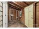 Unfinished utility room with wood walls and a bright yellow door at 407 Cherry St, Belmont, NC 28012