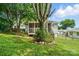 Landscaped backyard with lush lawn, established trees, and screened-in porch at 435 Sixteenth St, Cramerton, NC 28032