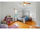 Bright bedroom with hardwood floors, canopy bed, and natural light at 435 Sixteenth St, Cramerton, NC 28032