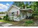 Attractive single-story home featuring a covered porch, red shutters, and manicured landscaping for welcoming appeal at 435 Sixteenth St, Cramerton, NC 28032