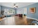 Open living room with hardwood floors, ceiling fan, and view into connecting bedroom at 435 Sixteenth St, Cramerton, NC 28032