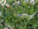 Aerial view of the house surrounded by lush green trees and vegetation at 4848 Spicewood Dr, Charlotte, NC 28227