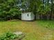 Backyard shed and greenery adds storage and enhances the charm of this landscaped backyard at 4848 Spicewood Dr, Charlotte, NC 28227