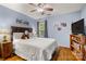 Cozy bedroom features a queen size bed, wood floors, and ample natural light from the window at 4848 Spicewood Dr, Charlotte, NC 28227