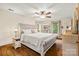 This main bedroom features a ceiling fan, a large bed, and dual windows for natural light at 4848 Spicewood Dr, Charlotte, NC 28227