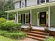 Inviting front porch with a swing and decorative plants leading up to the front door at 4848 Spicewood Dr, Charlotte, NC 28227