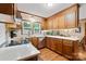 This kitchen features wood cabinetry, light countertops, a mosaic backsplash, and stainless-steel appliances at 4848 Spicewood Dr, Charlotte, NC 28227