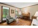Comfortable living room featuring hardwood floors, a cozy chair, and an upright piano at 4848 Spicewood Dr, Charlotte, NC 28227