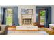 Bright living room with a whitewashed fireplace, exposed brick, and natural light at 4848 Spicewood Dr, Charlotte, NC 28227