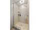 Modern shower features tiled walls, glass doors, rainfall shower head, and built-in shelving at 4848 Spicewood Dr, Charlotte, NC 28227