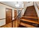 The staircase features hardwood stairs and banister leading to the upper level at 4848 Spicewood Dr, Charlotte, NC 28227