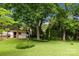 Spacious backyard with lush lawn and mature trees, creating a serene outdoor space at 4913 Seacroft Rd, Charlotte, NC 28210