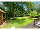 Lush backyard with green grass and mature trees, perfect for outdoor activities at 4913 Seacroft Rd, Charlotte, NC 28210