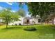 Well-maintained backyard with lush lawn and mature trees, offering privacy and tranquility at 4913 Seacroft Rd, Charlotte, NC 28210