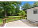 Spacious backyard featuring a patio, lush green lawn, and mature trees at 4913 Seacroft Rd, Charlotte, NC 28210