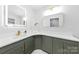 Bathroom featuring dual mirrors, modern hardware, and a vanity with ample counter space at 4913 Seacroft Rd, Charlotte, NC 28210